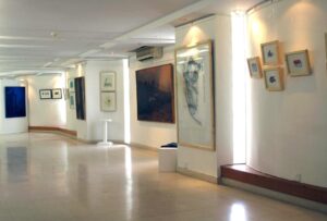 Modern exhibition space at an Online Art Gallery in Karachi showcasing contemporary Pakistani paintings.